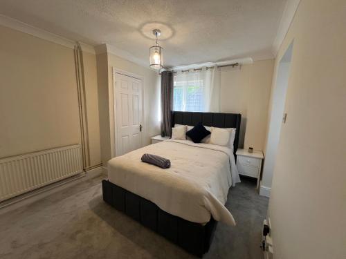 a bedroom with a large bed and a window at Summerhill by suspire in Ashford