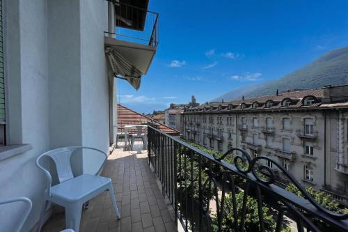 a balcony with a chair and a view of a building at Bellinzona Center in Bellinzona