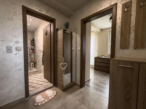 a bathroom with a walk in shower and a glass door at Desitas home in Plovdiv