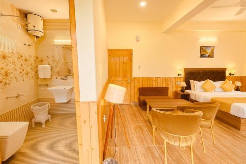 a hotel room with a bed and a bathroom at Hotel The Winterline - Best Selling Property in Kasol 2025-26 in Kasol