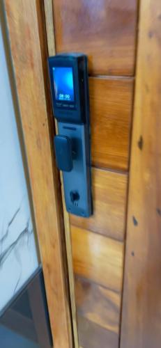 a television is attached to a wooden wall at Vineyardcourts Apartment in Lagos