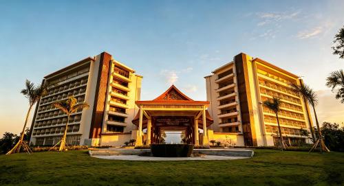 two tall buildings with a gate in a park at NDC Resort & Spa in Manado
