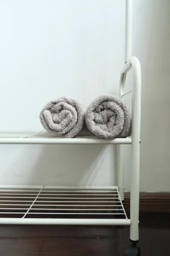 a couple of towels are sitting on a shelf at Kim_Homestay in Tawau