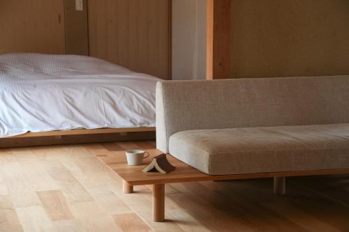 a living room with a couch and a bed at 宿屋 余白丨yadoya yohaku in Wakayama