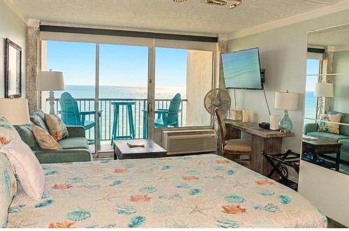 a bedroom with a bed and a view of the ocean at Beachfront 8th floor Studio - Stunning View in Galveston