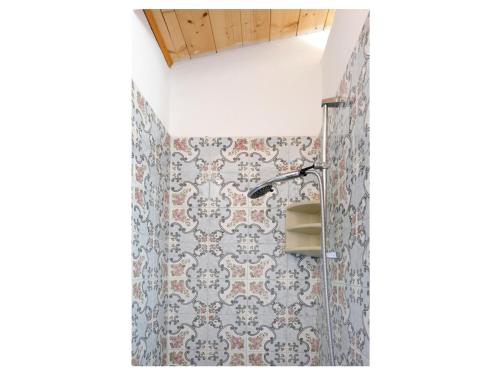 a bathroom with a shower curtain and a sink at Salina Holiday Home in Calasetta