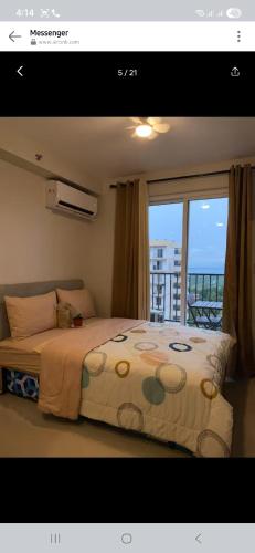 a bedroom with a bed with a view of a balcony at Pinili Homestay in Suba