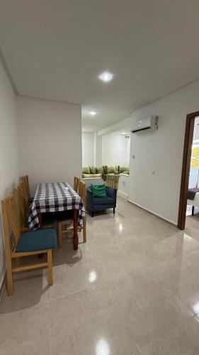 a living room with a table and chairs at Ventana al mar in Tangier