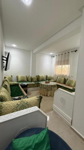 a living room with couches and chairs in a room at Ventana al mar in Tangier