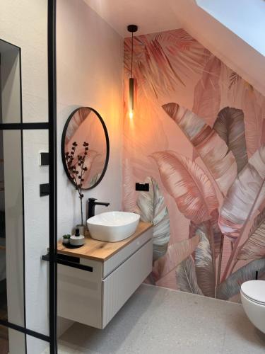 a bathroom with a sink and a mirror at Opal Villa in Băile Tuşnad