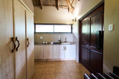 a small kitchen with a sink and a window at Sable Ranch Thaba Khaya Lodge in Brits