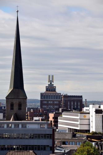 a view of a city with a church steeple at Days Inn Dortmund West in Dortmund
