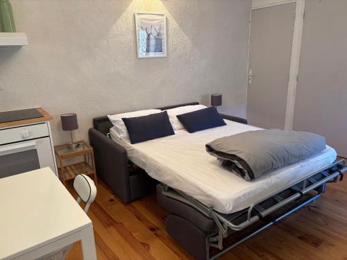 a hospital bed in a room with a table at Le Châtaignier in Faveyrolles