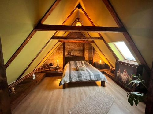 an attic bedroom with a bed in a attic at Boutique 11 Postavarului by Kronstay in Braşov