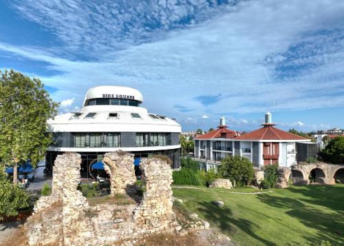 a building with a dome on top of a field at Side Square Hotel Adults Only in Side