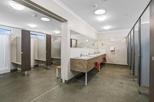 a bathroom with two sinks and a large mirror at Apollo Bay Holiday Park in Apollo Bay