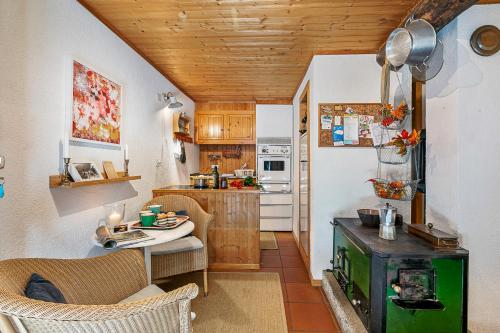 a small kitchen with a table and a stove at Rustico Stock with free wifi- Happy Rentals in Lugano