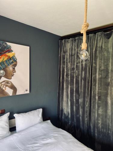 a bedroom with a bed and a black curtain at Elia in Ptolemaida