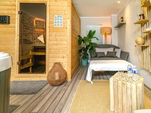 a room with a bed and a glass door at Domaine de la Jarrige in Saint-Vaury