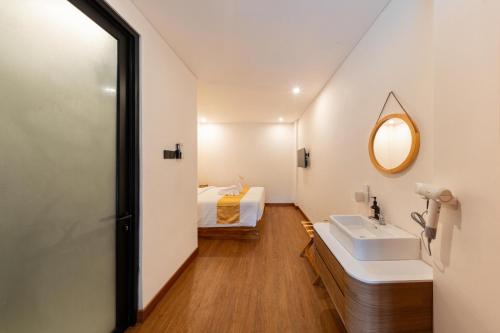 a bathroom with a sink and a bed at Sekala CoLiving Canggu - Minutes away to Finns and Atlas Beach Clubs in Canggu