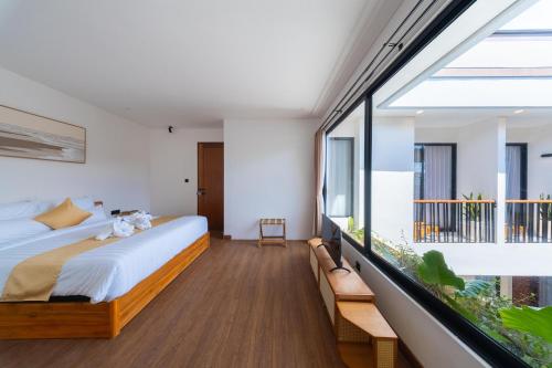 a bedroom with a bed and a large window at Sekala CoLiving Canggu - Minutes away to Finns and Atlas Beach Clubs in Canggu