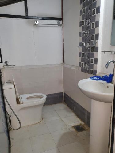 a bathroom with a toilet and a sink at Newari chulo ghar in Bhaktapur
