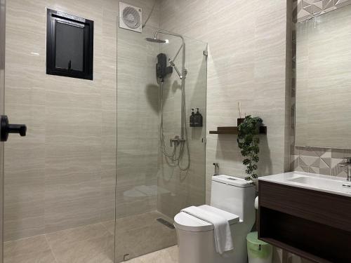 a bathroom with a shower and a toilet and a sink at Pomt Lagoon in Ban Khlong Dan