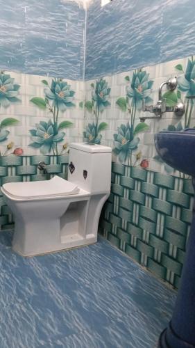 a bathroom with a toilet and a sink at Punchkedar in Phata