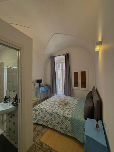 a bedroom with a bed and a sink and a mirror at Old Town in Castellana Grotte