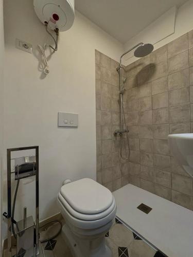 a bathroom with a toilet and a shower and a sink at Old Town in Castellana Grotte