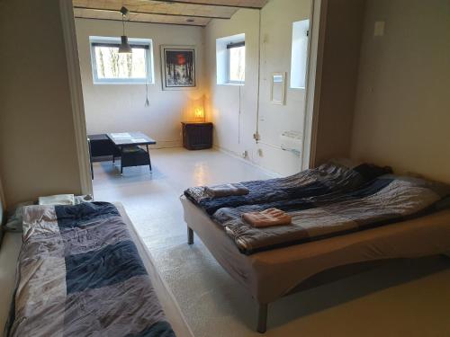 a room with two beds and a table in it at Nordborg Apartment Hejnsvi in Hejnsvig