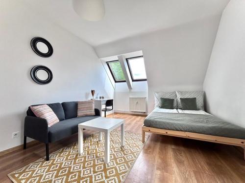 a living room with a bed and a couch at OLD TOWN Olsztyn in Olsztyn
