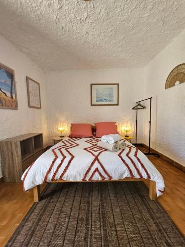 a bedroom with a large bed with red pillows at Cocody in Lumio