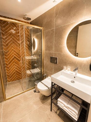 a bathroom with a sink and a toilet and a shower at The Tram Karakoy in Istanbul