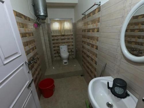 a small bathroom with a sink and a toilet at Salena Homestay in Cherrapunji