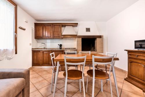 a kitchen with a wooden table and chairs at Eden Beach House - Host Solution in Cavallino-Treporti