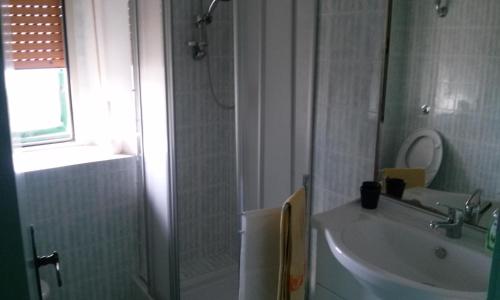 a bathroom with a sink and a toilet and a window at Via del Mare in Termoli