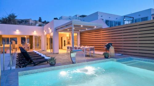 a swimming pool in the backyard of a house at Villa Ida - Indoor Heated Pool, Sauna, Games Room and Gym in Mellieħa