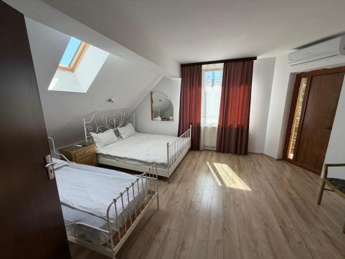 a room with two beds and a window in it at Hypnotic Boutique Pitesti in Piteşti