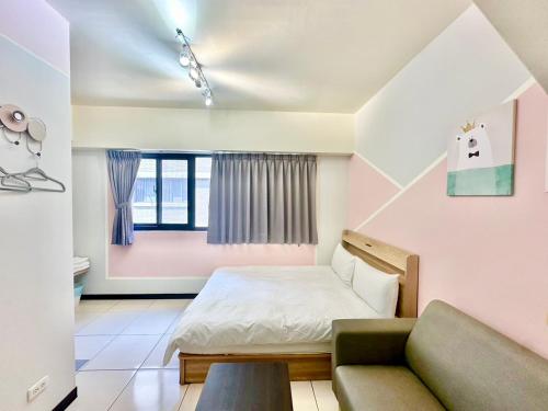 a small bedroom with a bed and a couch at 卡布里 in Taichung