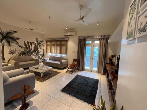 a living room with a couch and a table at Cozy Loft 201 2 BHK in Jaipur