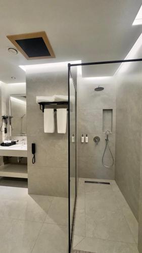 a bathroom with a shower with a glass door at Grand Afrosiyob Hotel in Tashkent