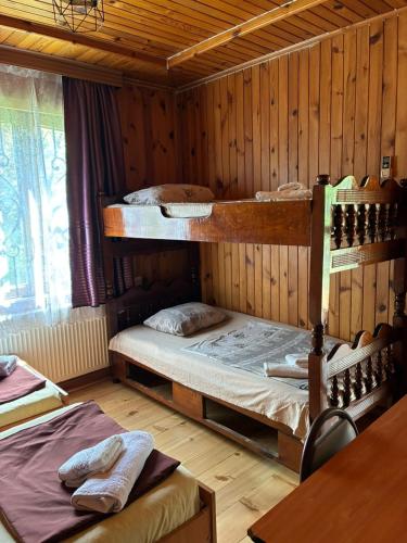 a room with two bunk beds in a cabin at Wooden Cottage in Makhinjauri
