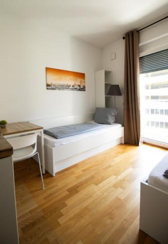 a bedroom with a bed and a desk at MyRoom - Top Munich Serviced Apartments in Munich