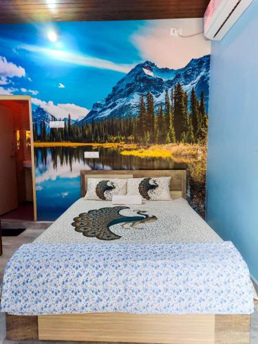 a bedroom with a bed with a mountain mural at Hampi Banana Farm House in Hospet