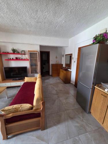 a living room with a couch and a refrigerator at Poly Nest House in Polychrono