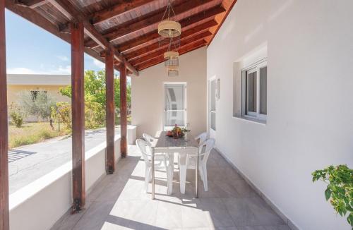 a dining room with a table and chairs on a patio at Pastida Olive Home in Pastida