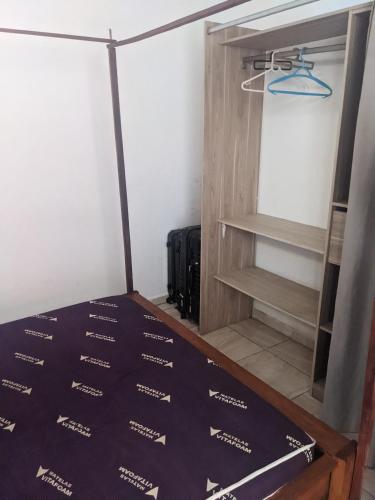 a room with a wine cellar with a door and a shelf at Appartement VIDA 1 in Mahajanga