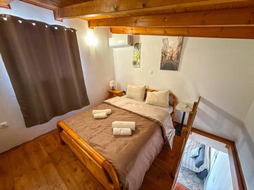 a bedroom with a bed with two towels on it at Seafront blue in Áyios Spirídhon