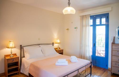 a bedroom with a bed with two towels on it at Yasmin House in Perdika